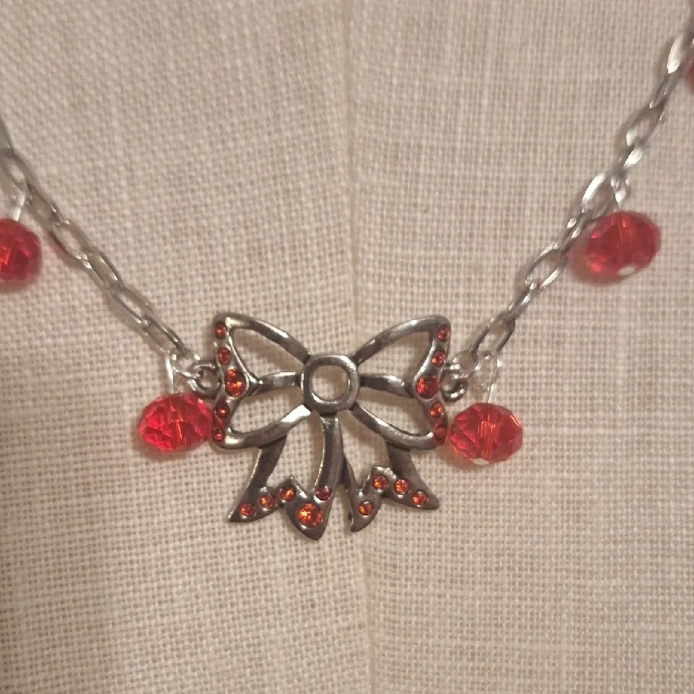 Elegant Silver and Red Bow Necklace